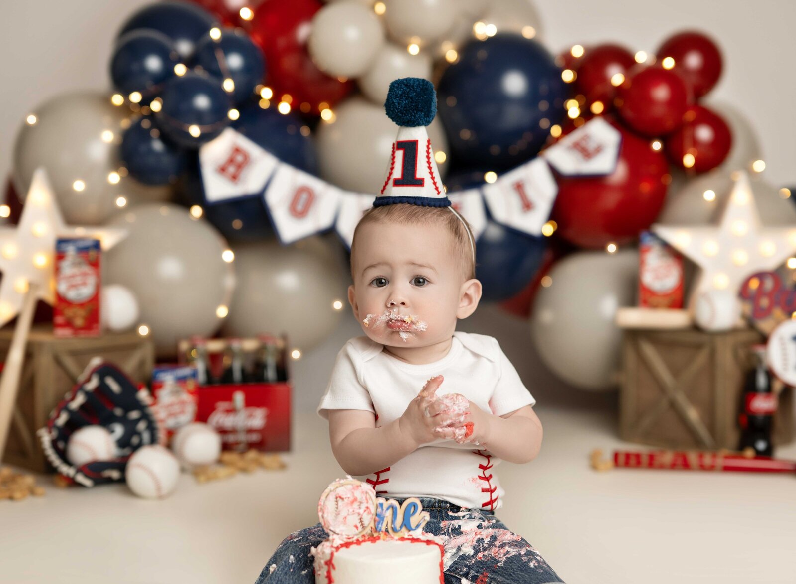 1st birthday photos of baby boy playing in cake. Studio cake smash photo taken by Jenni Nikki Photography in Atlanta, GA.