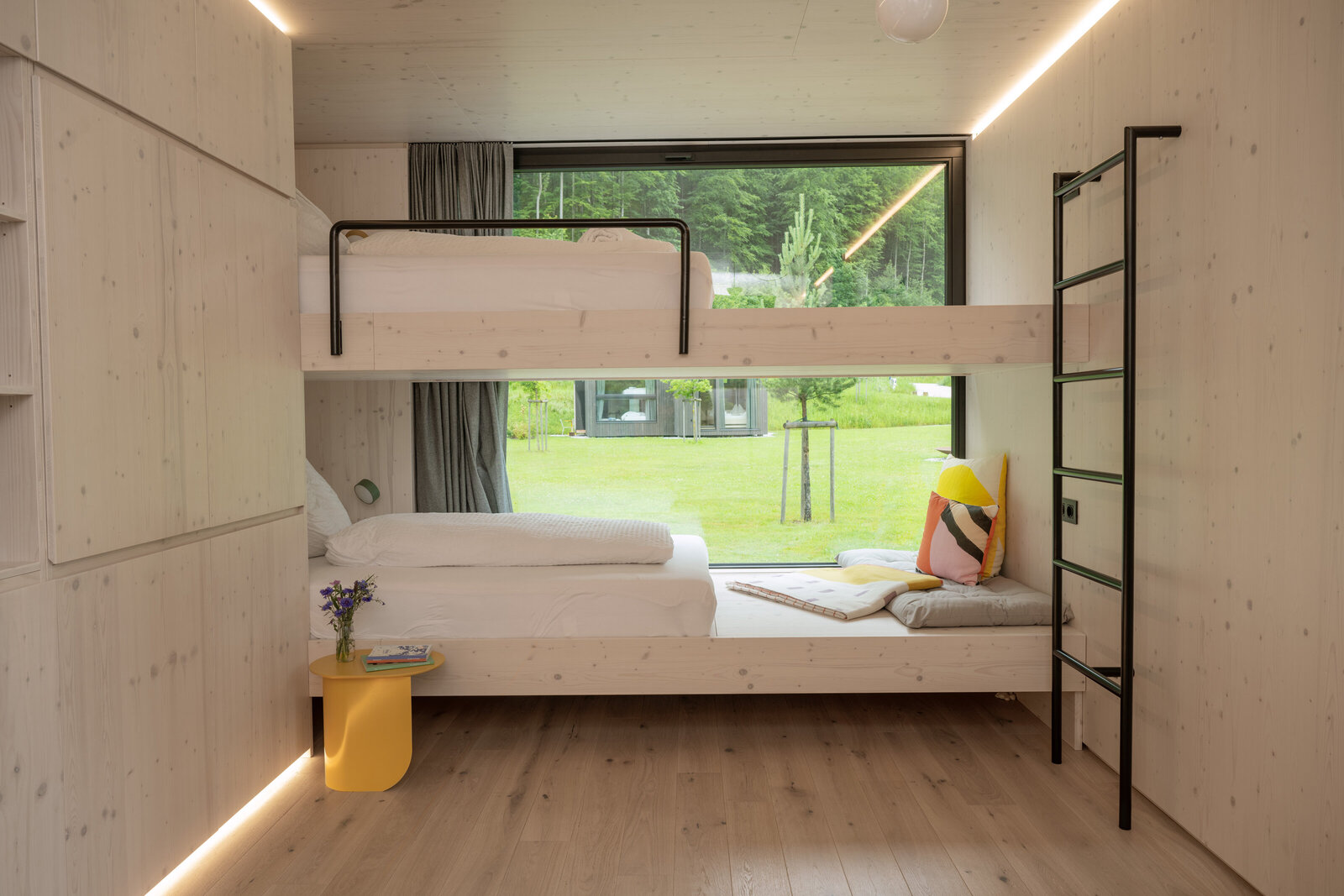 Full view of a cozy bunk bed inside a Tiny Home at The Campus Alps.com, providing comfortable and functional accommodation