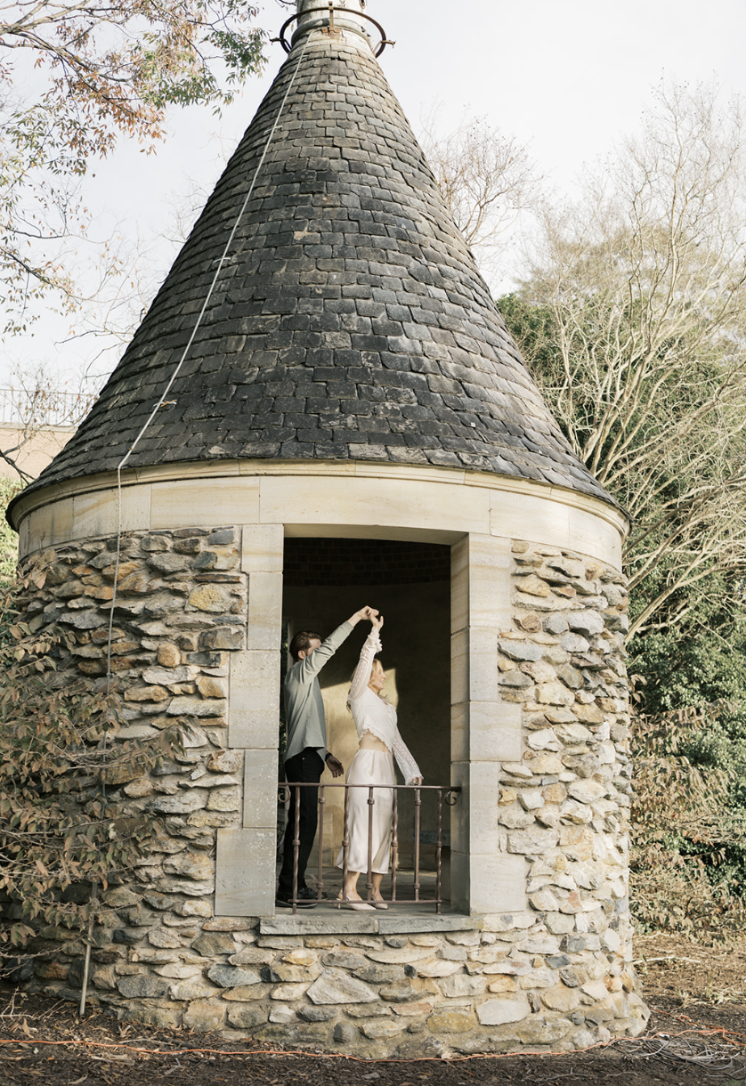 Groom twirling bride in the top of a castle at their wedding reception | Megan Smith Photography