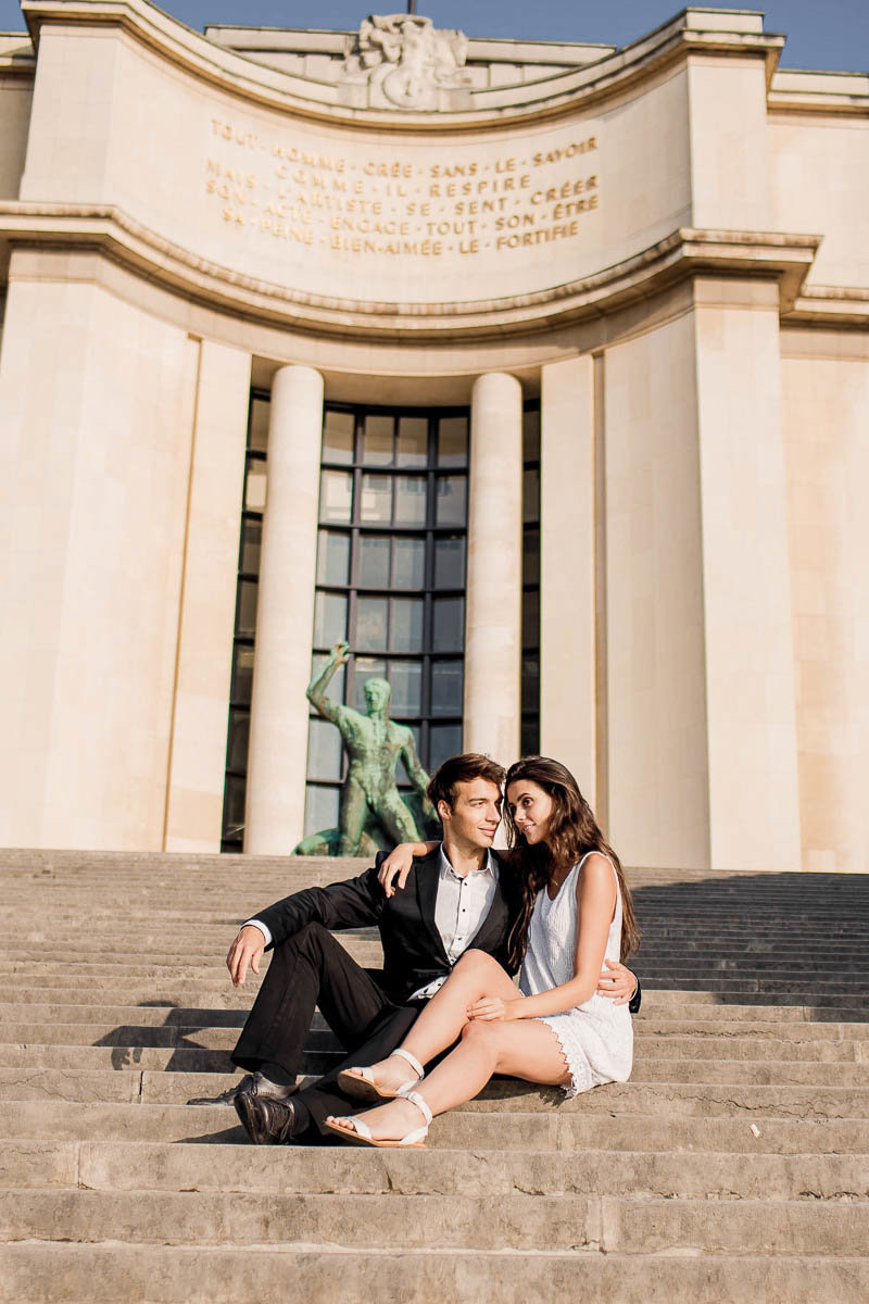 Bride and groom sit on the steps with Hercules behind them, Palais de Chaillot, Paris, France