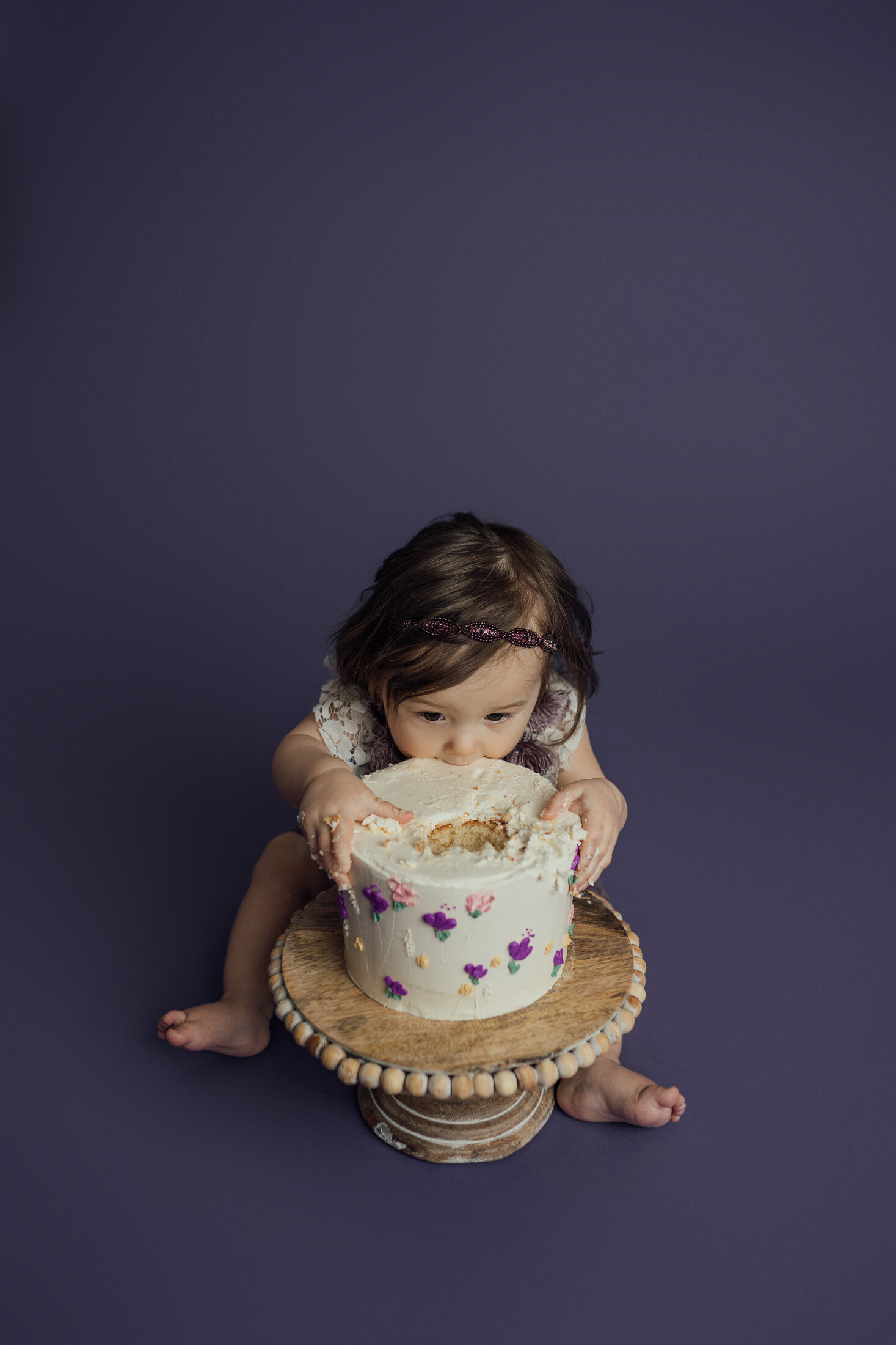 girl eating cake during cake smash session in Clearwater