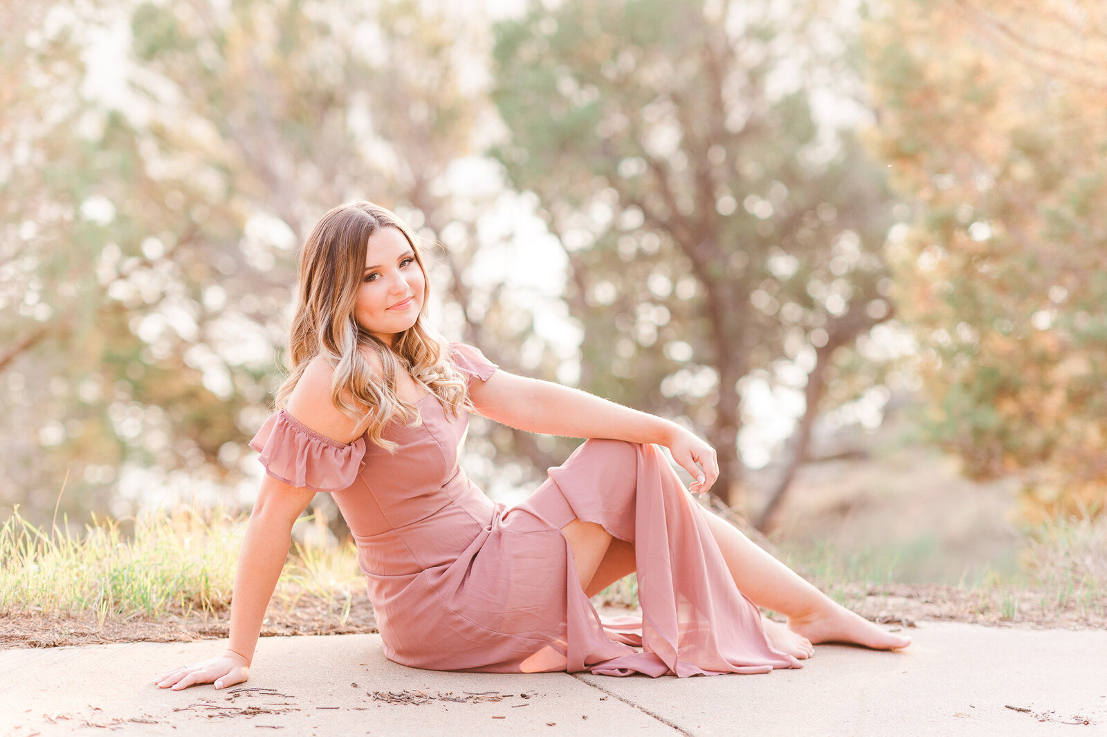 senior session with girl sitting down leaning back on hand