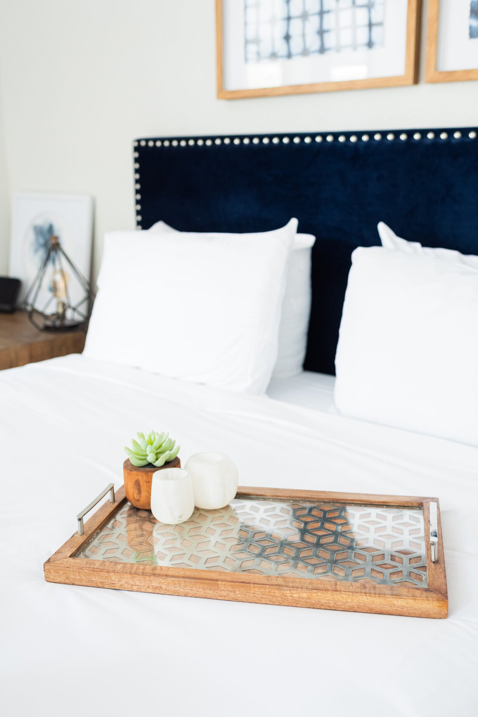 Stylish bedroom in a luxury NYC apartment with a decorative tray and modern furnishings