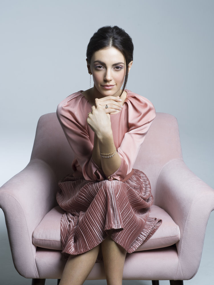 Natural makeup for model sitting in pink chair in a pink dress