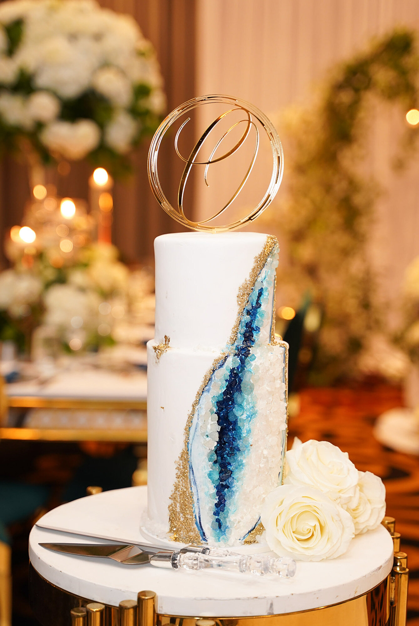 luxury wedding cake design with gemstone and floral touches