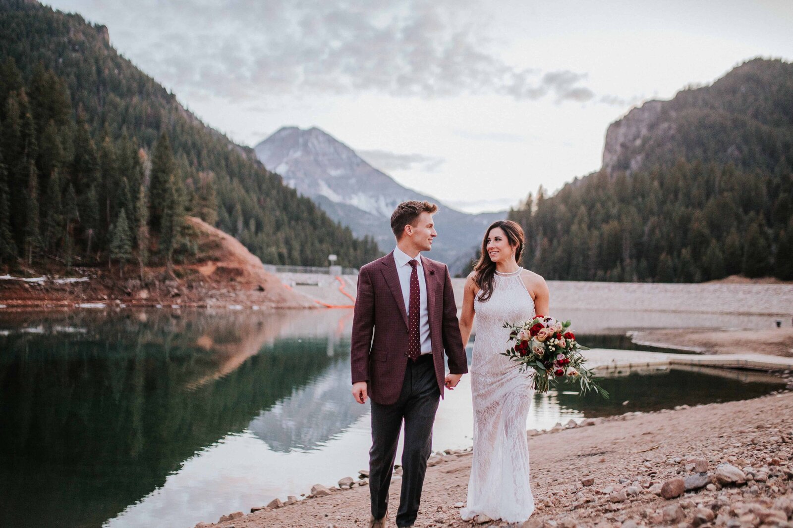 Lake Tahoe wedding photographer captures bride and groom walking on Lake Tahoe beach