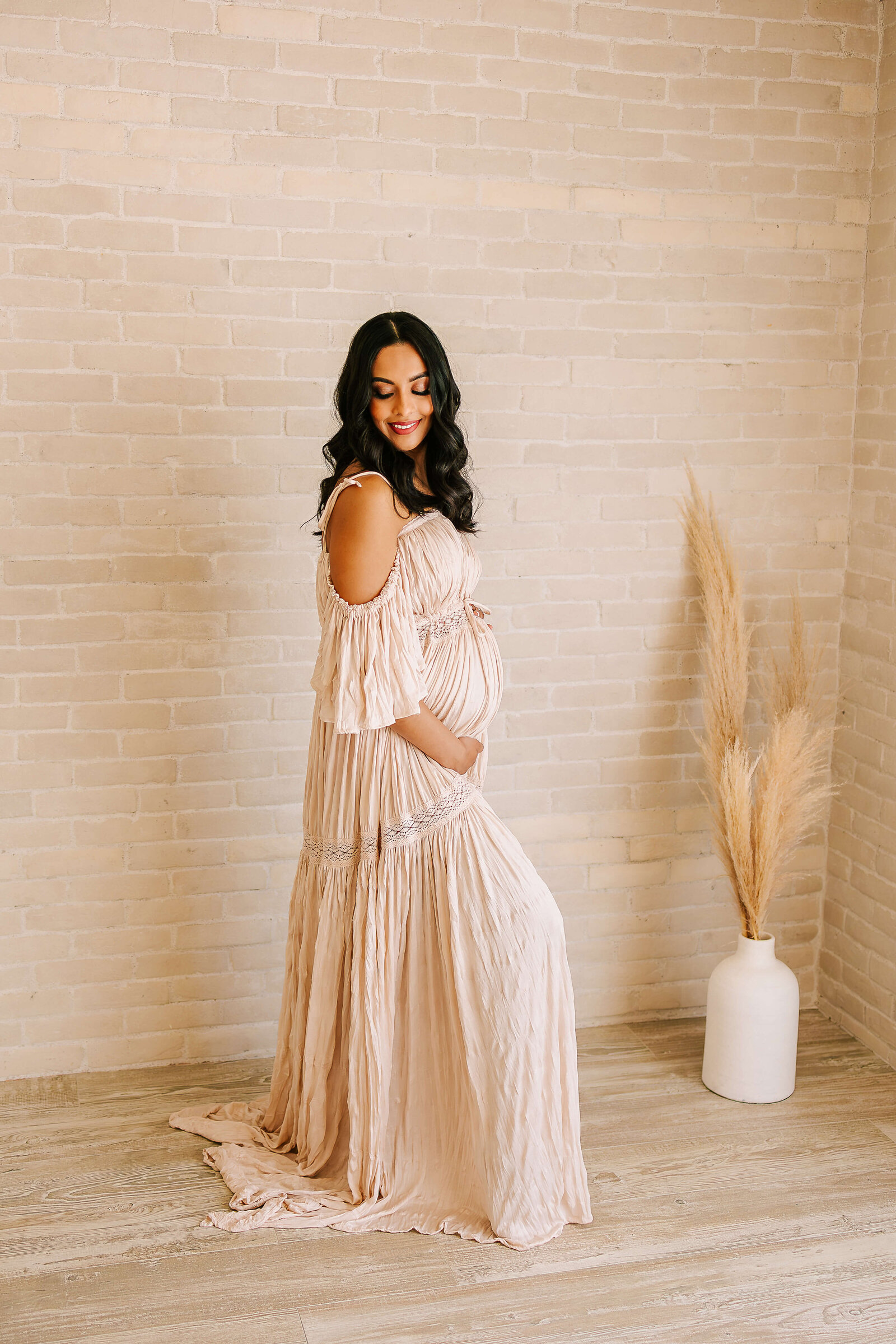 Expectnat mom wearing reclamation dress in natural boho studion in Orange County by Ashley Nicole Photography.
