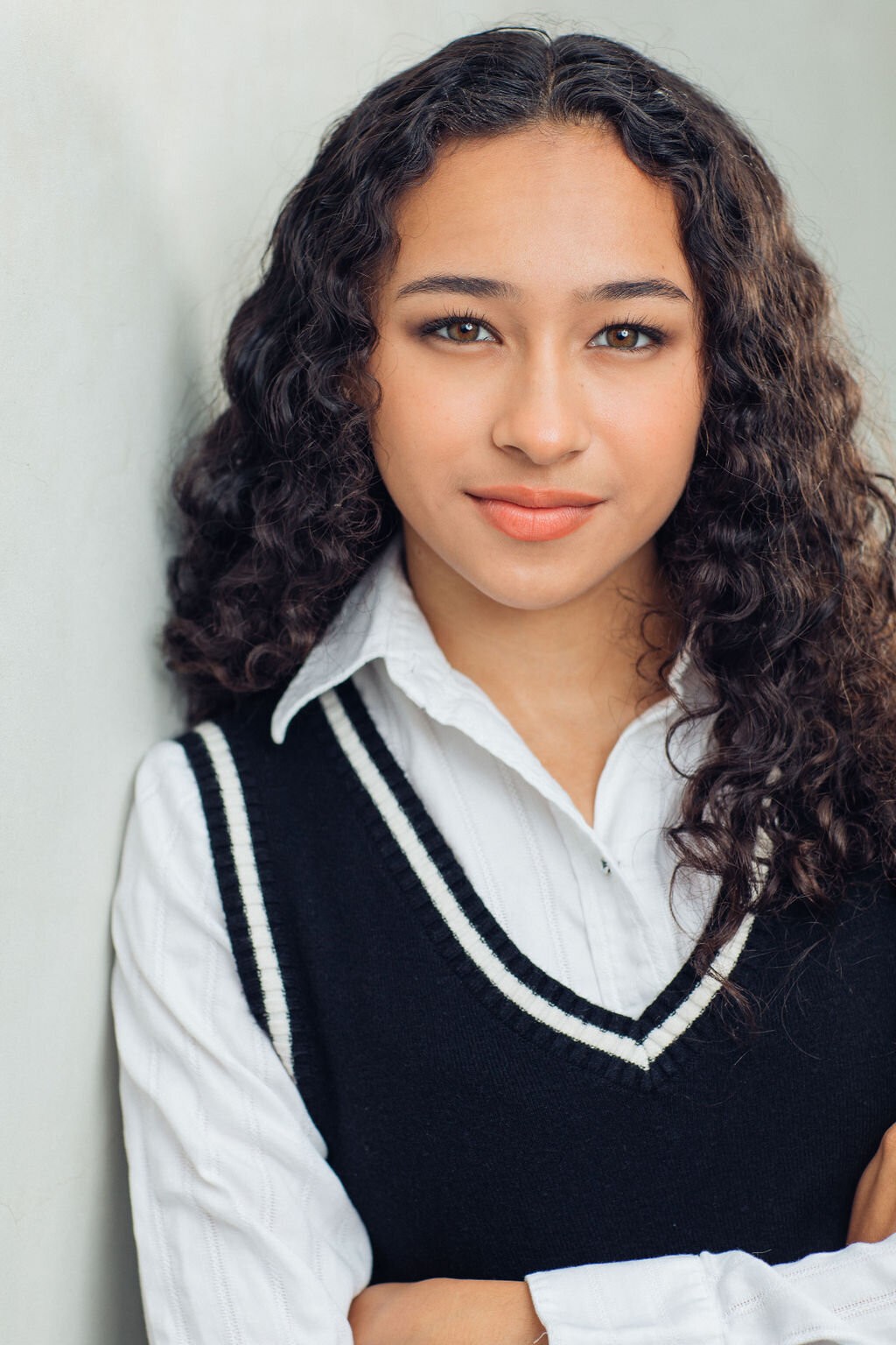 Headshot Photograph Of Young Woman In Black Vest And White Long Sleeves Polo Los Angeles