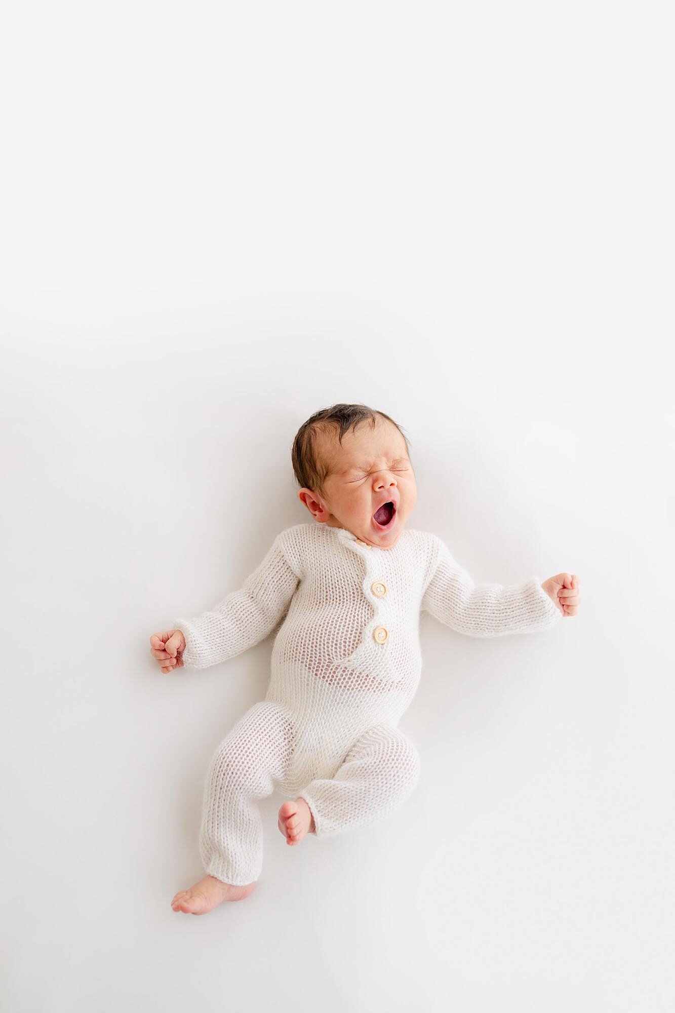 a sweet yawning newborn during an in studio session