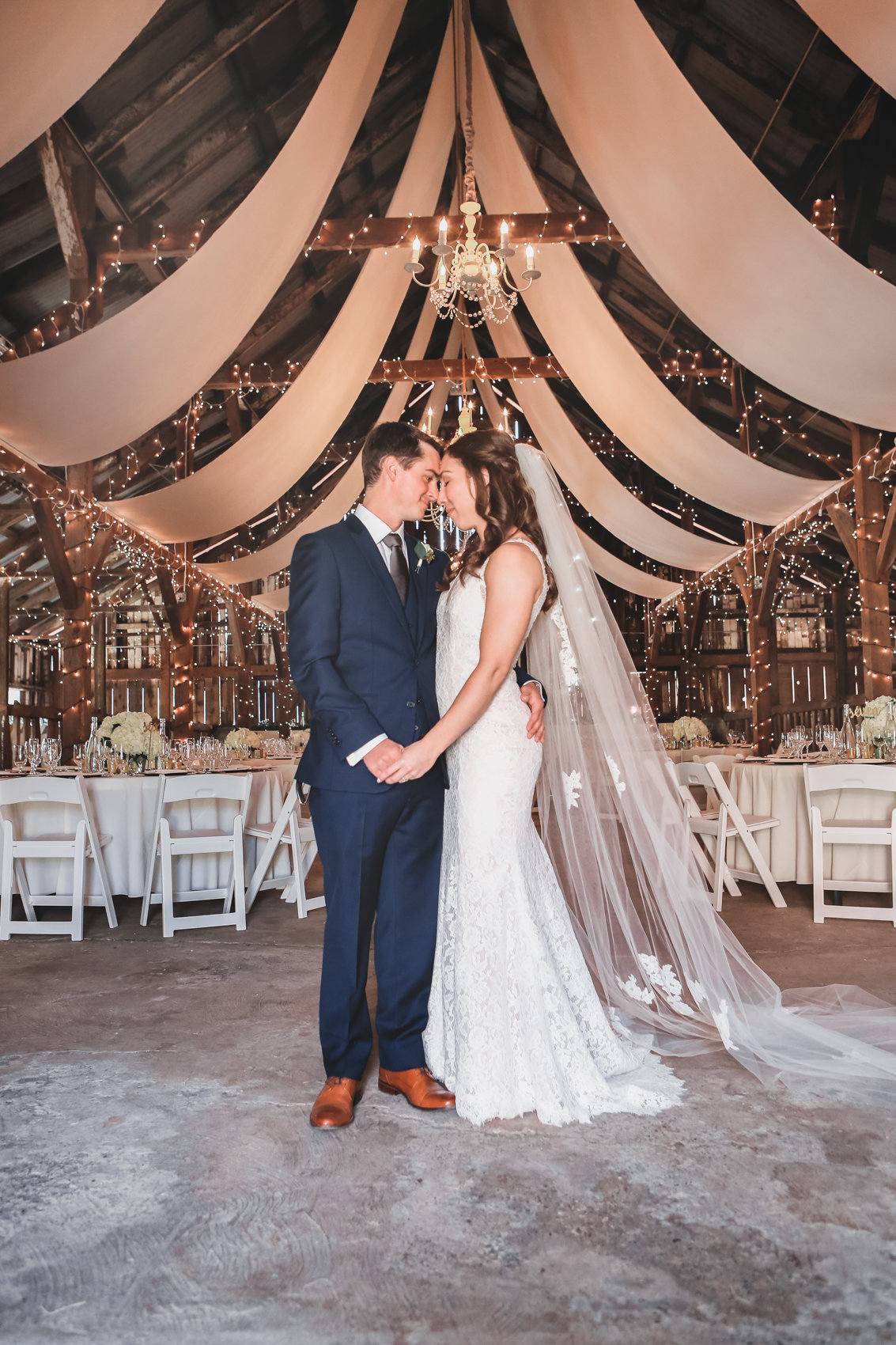 Tented rustic wedding provides beautiful backdrop for portrait of bride and groom