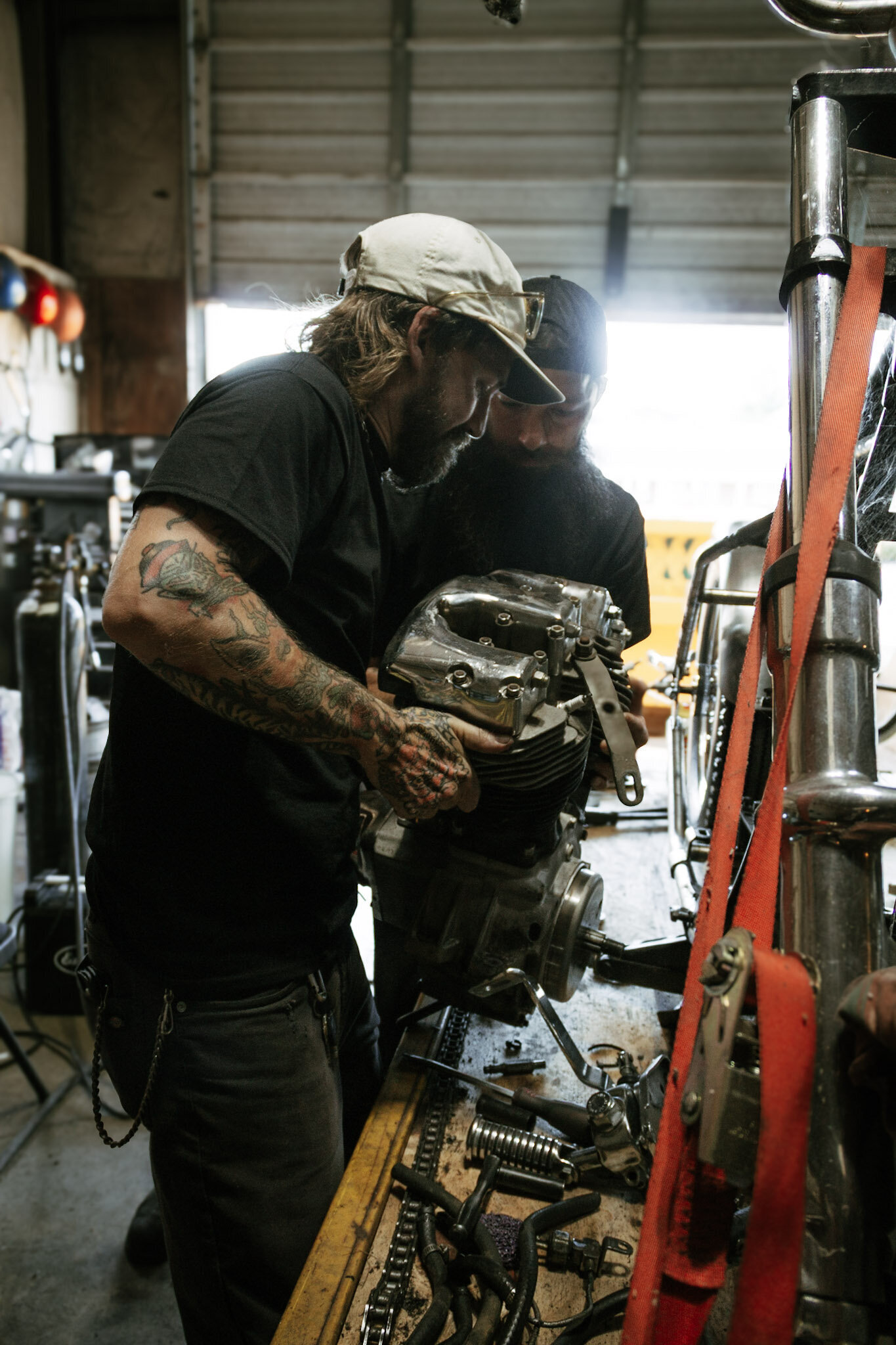King City Choppers' Drew holding a Shovelhead Harley engine. 