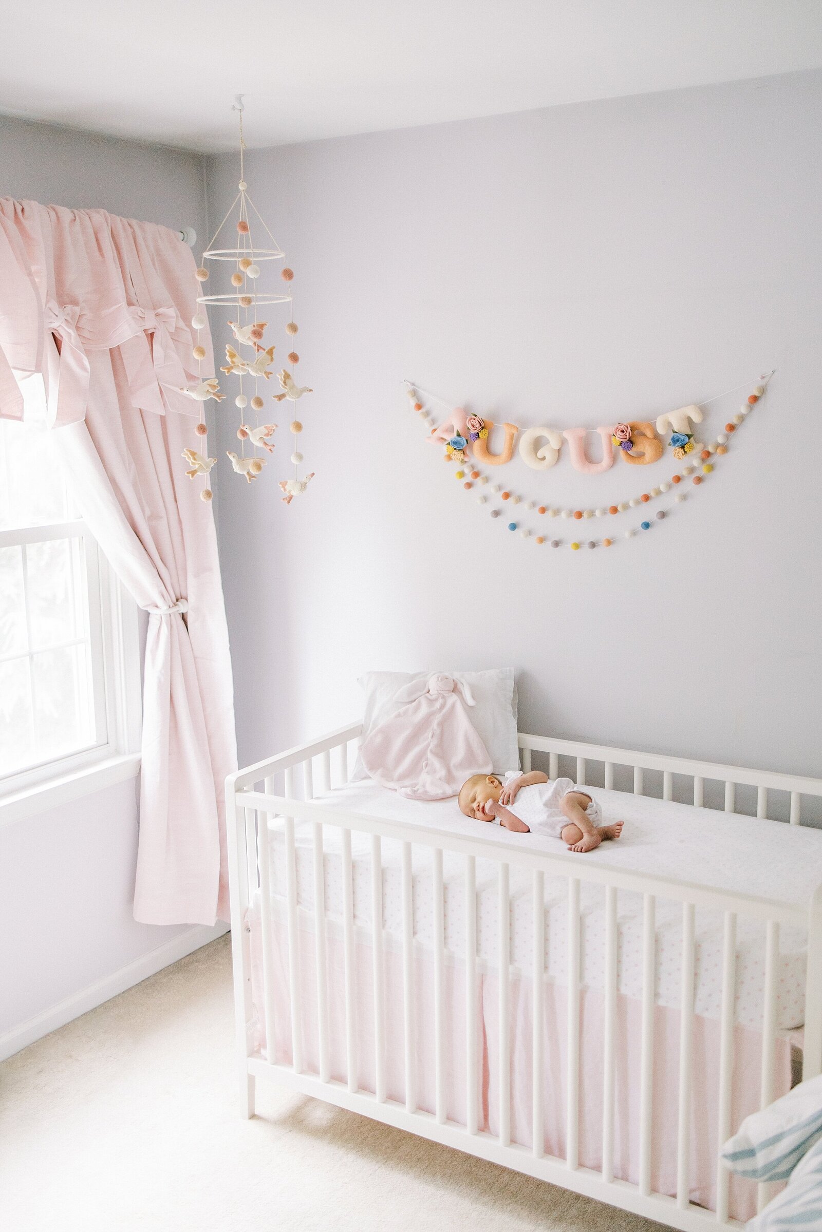 baby girl in crib in nursery Newborn Photography West Chester PA