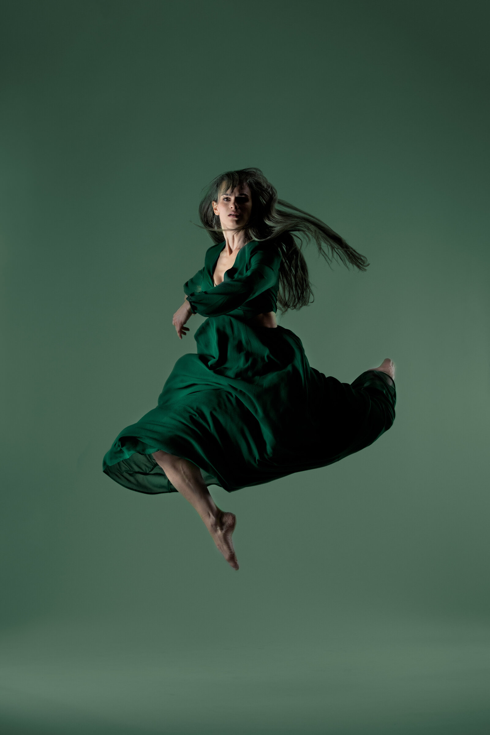 Female dancer jumping with bold background