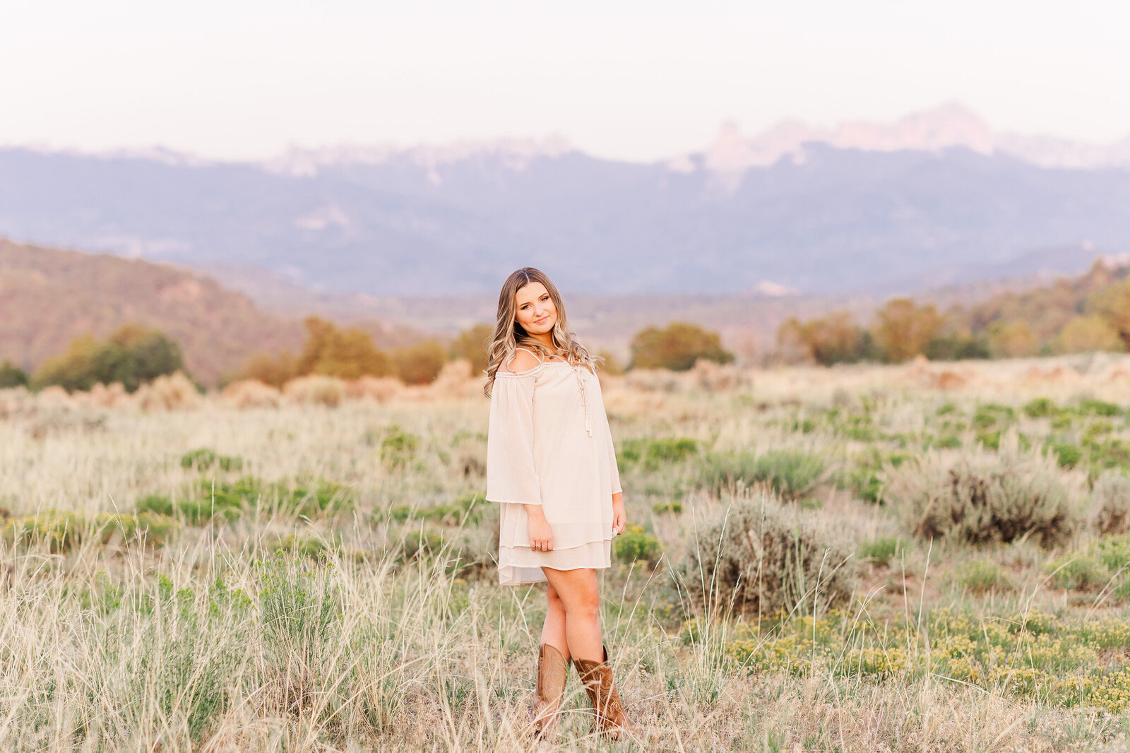 cream colored dress and cowboy boots photo