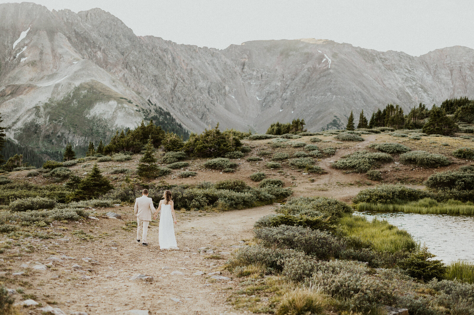 Couple standing in alpine meadow during their Aspen elopement