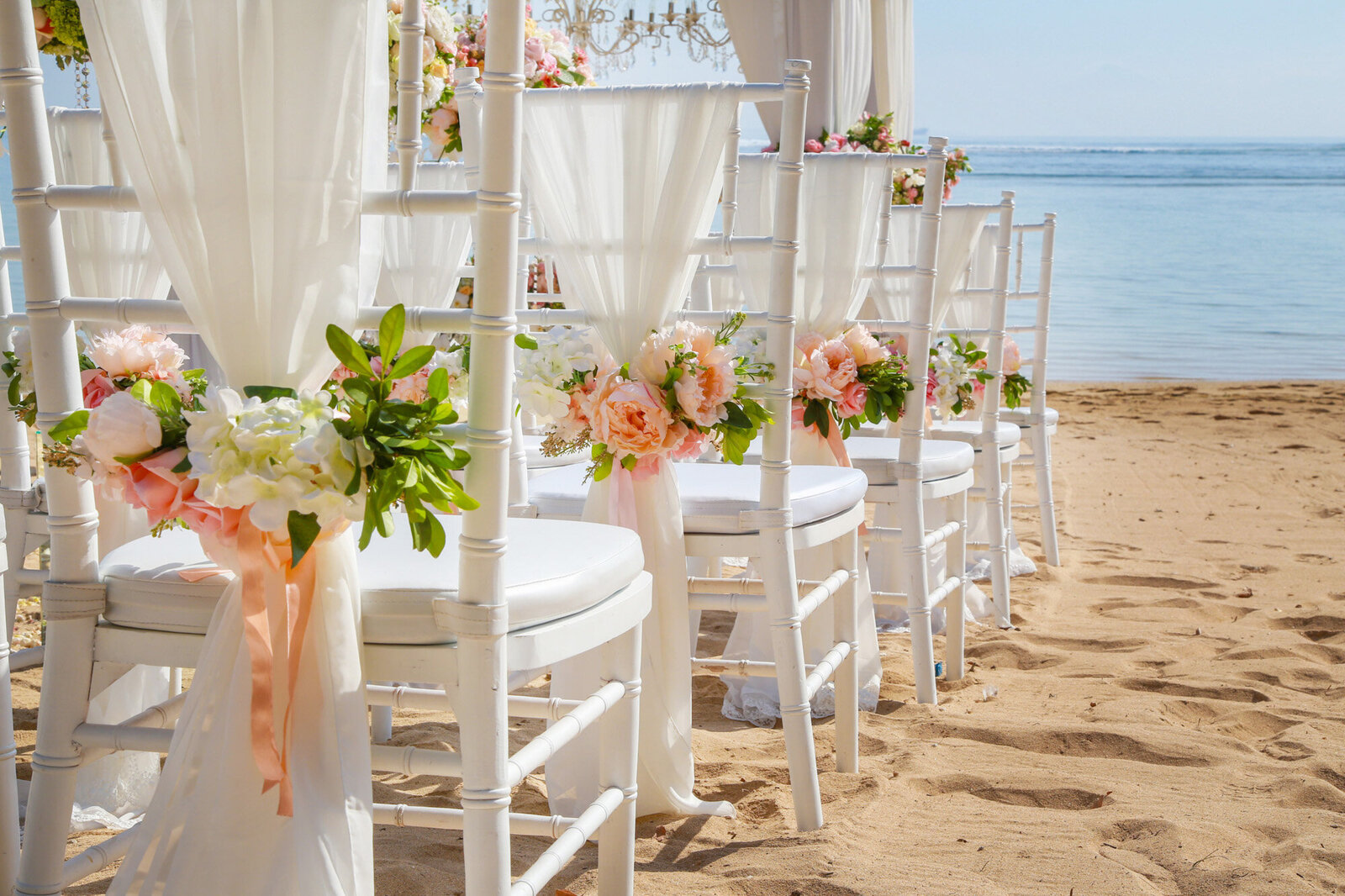 Wedding reception chairs with florals at the seaside