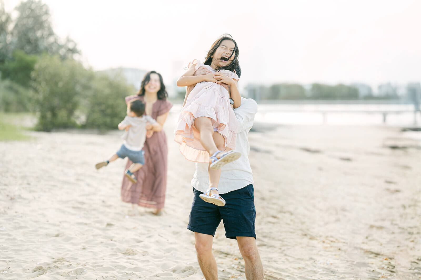joyful-playing-children-and-parents-beach-family-photo