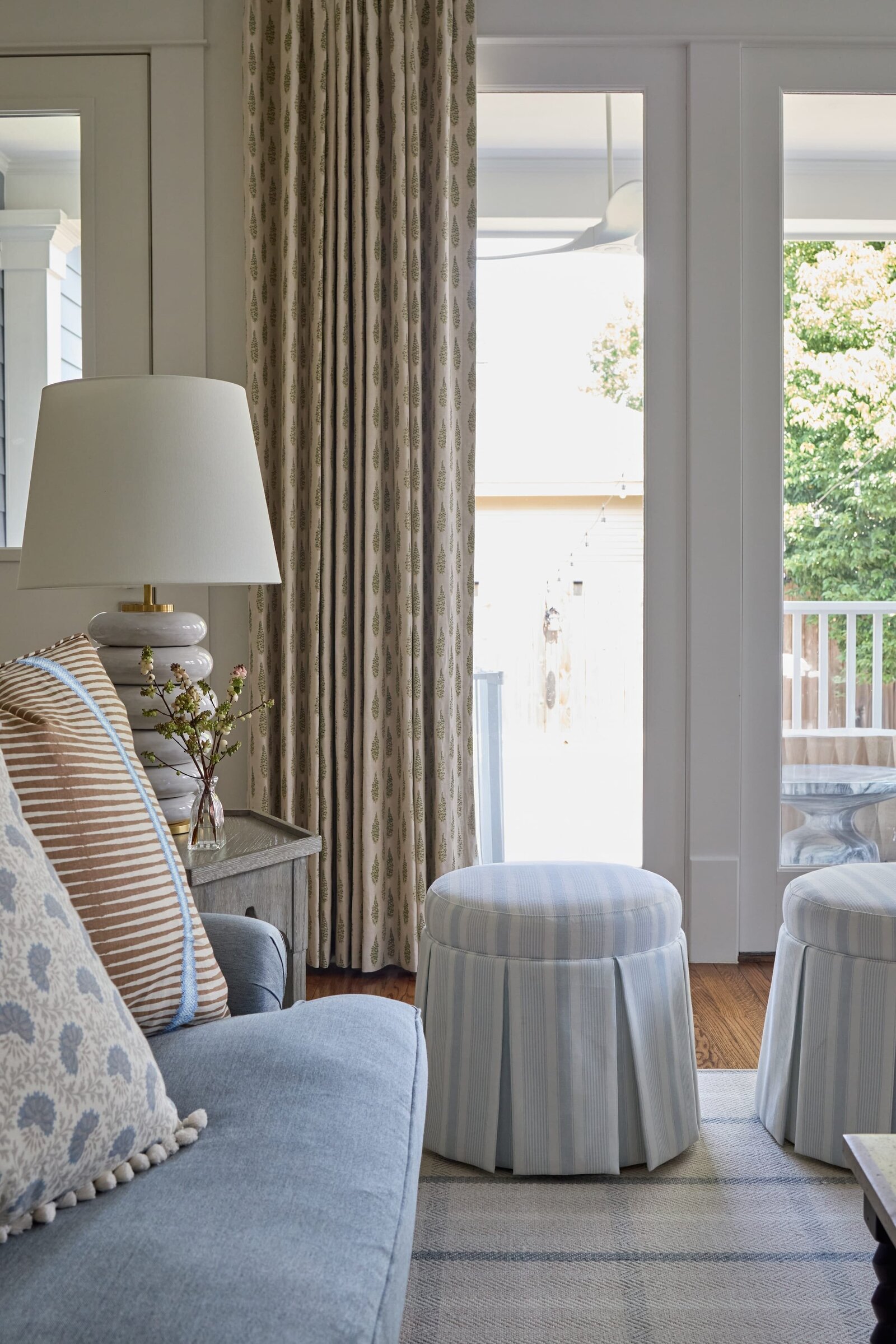 vision and hammer living room with blue sofa and large window and door