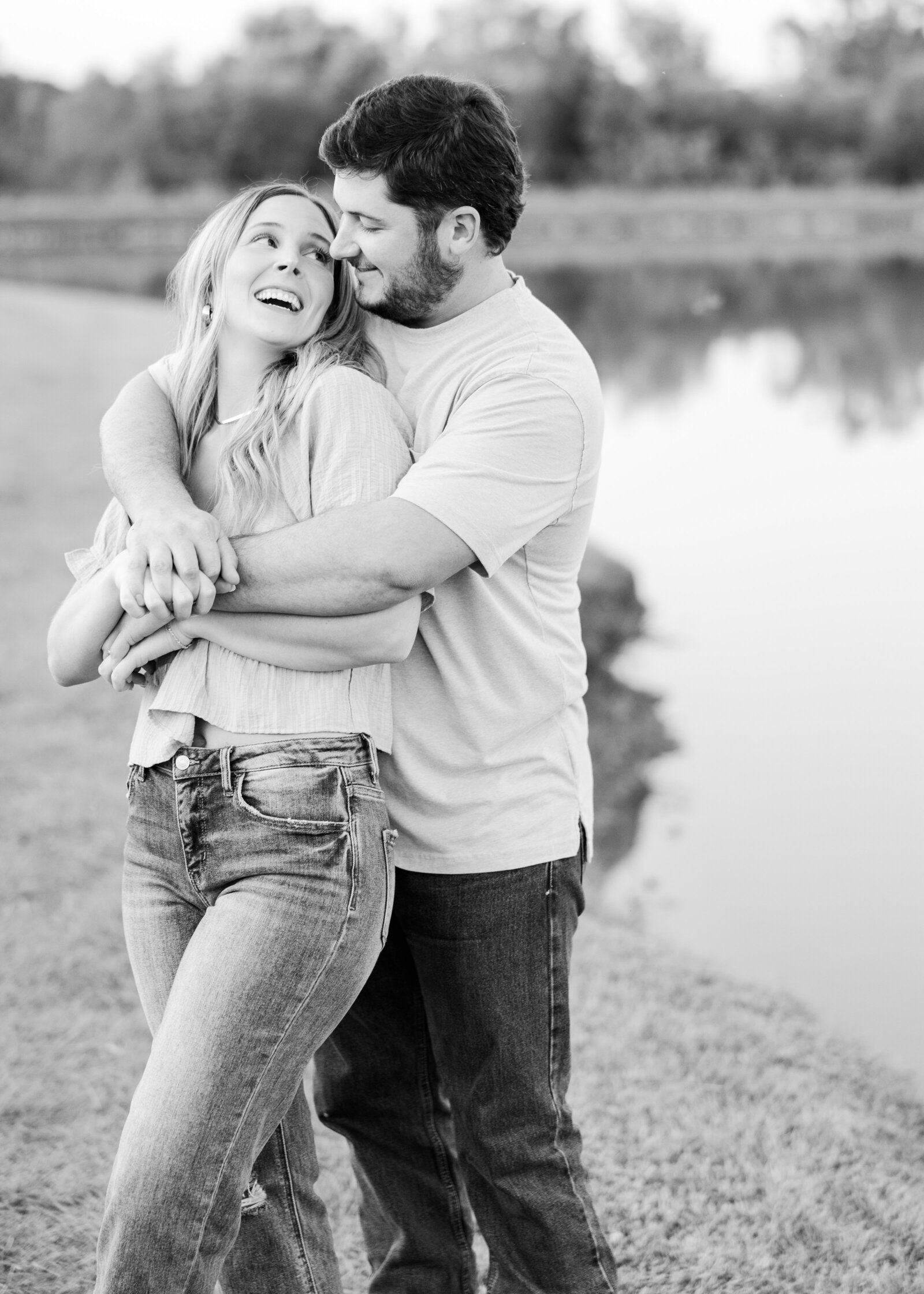 Kelby and Mason enjoying a serene moment in an Alabama meadow, captured by Abby Bell Photography. Personalized and timeless couples photography.