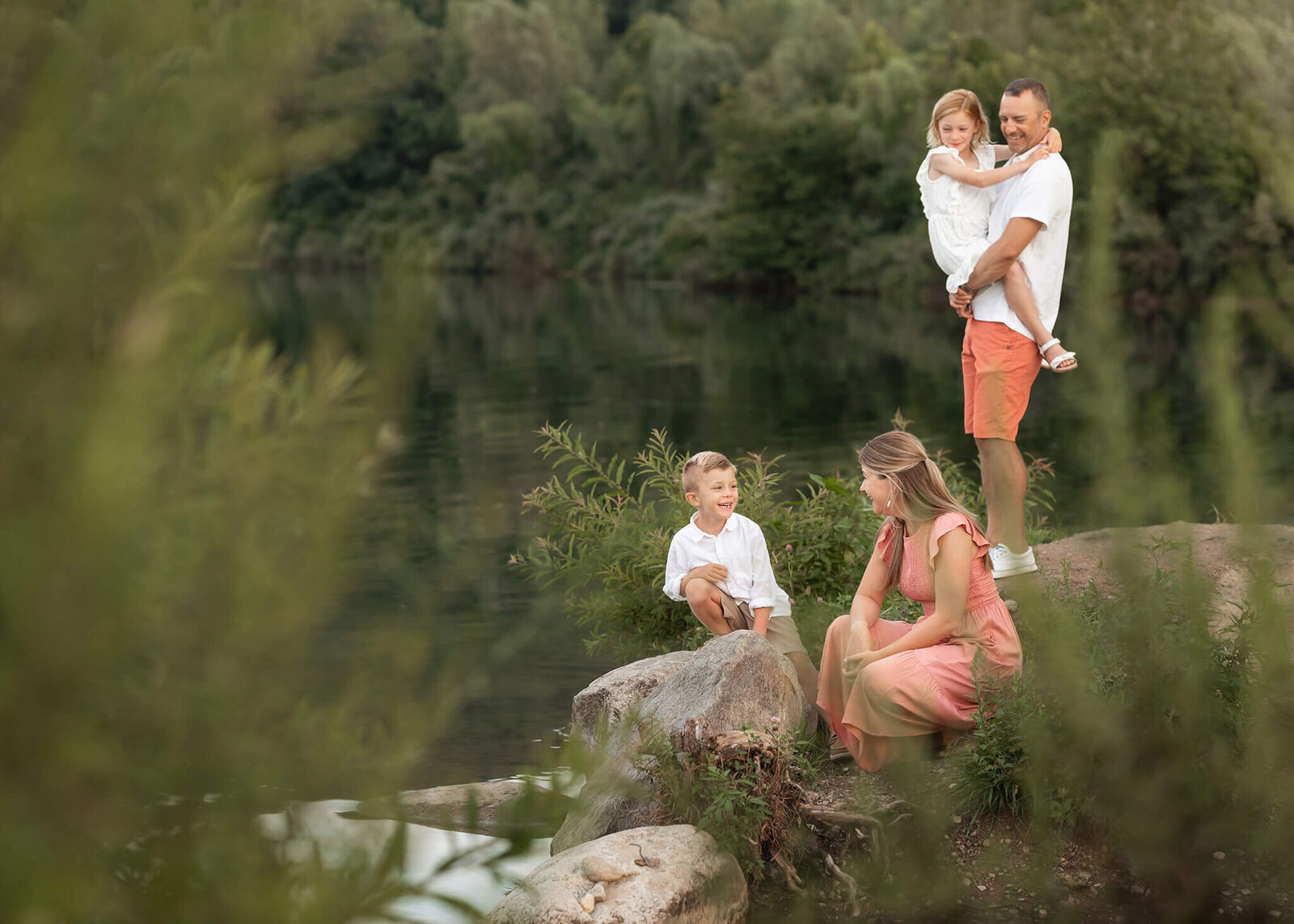 Family in Byram, NJ plays near a lake and skips rocks