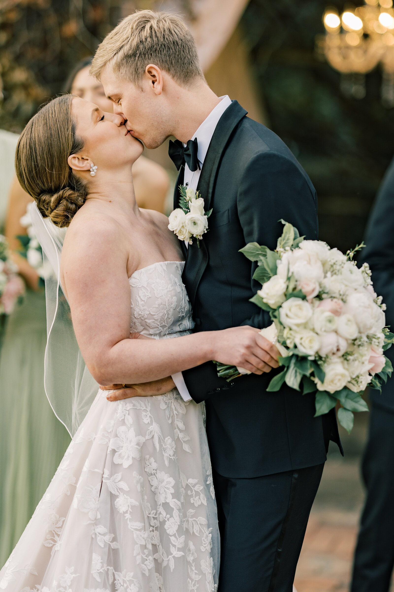 Bride and groom share a kiss after going through a tunnel of their bridal party at Inola, Blue Ridge. 
