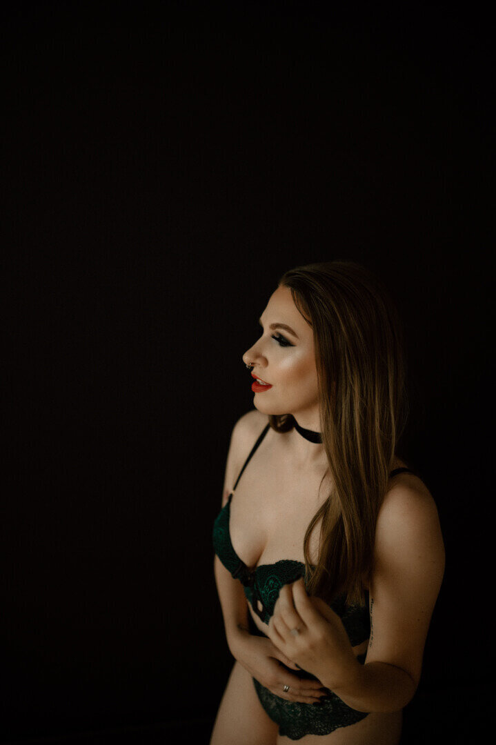 woman in lace lingerie in front of dark background
