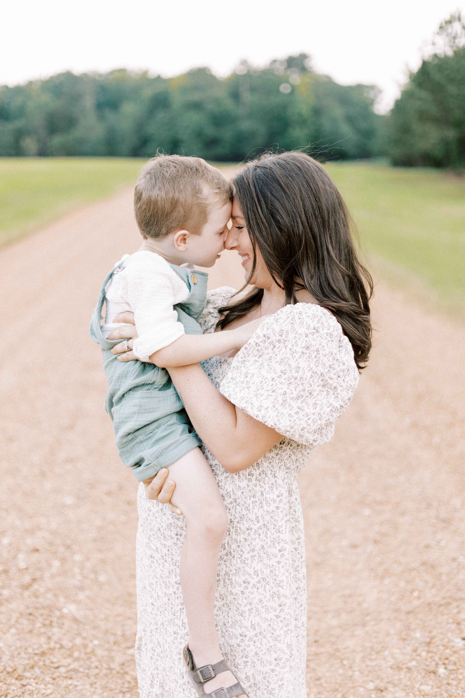 mom holding child while pregnant during peoria illinois maternity photos 