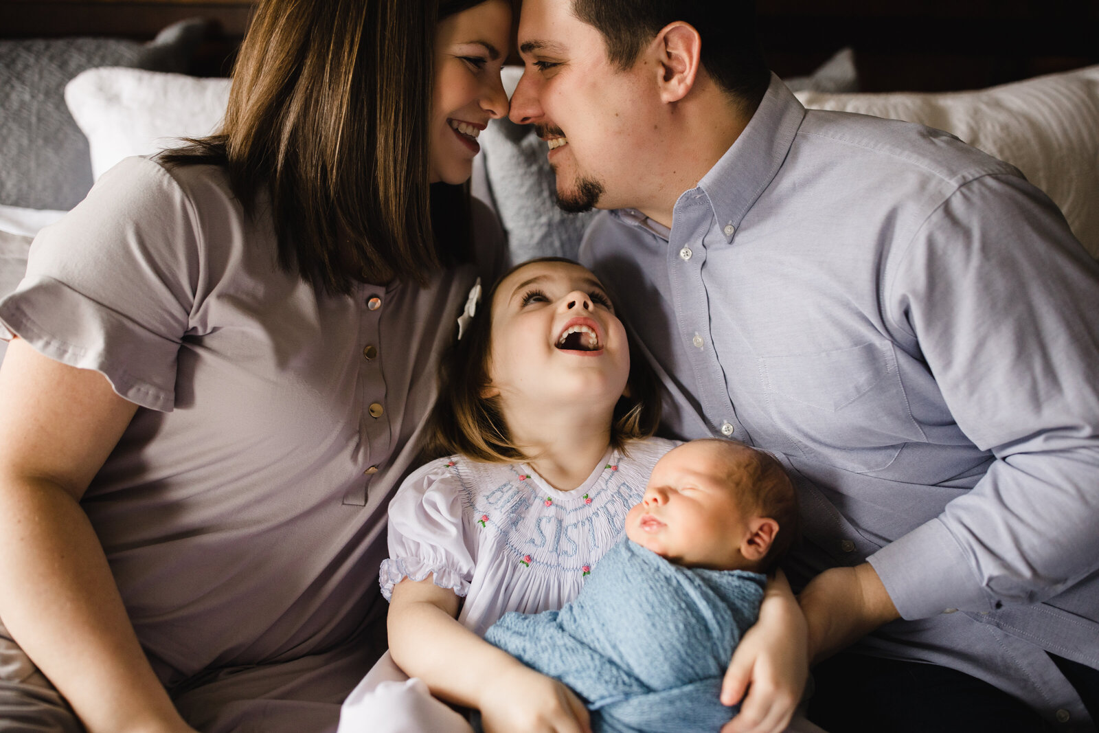 Family laughs during lifestyle newborn session near Birmingham
