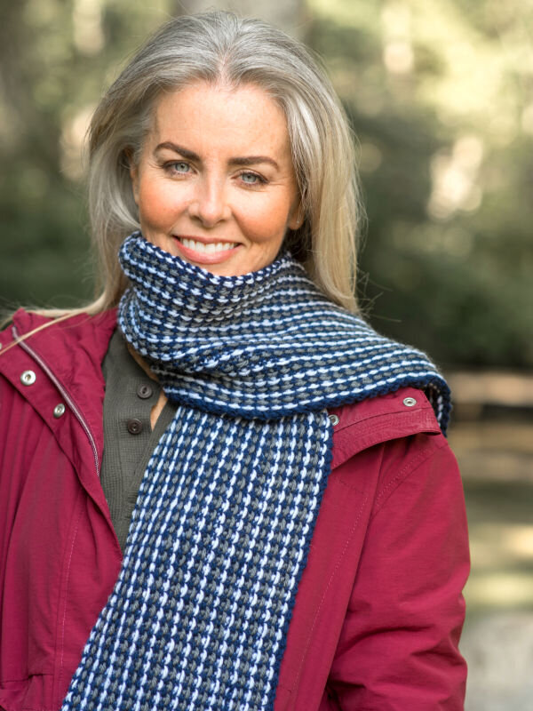Natural makeup for a model with grey hair wearing a red jacket
