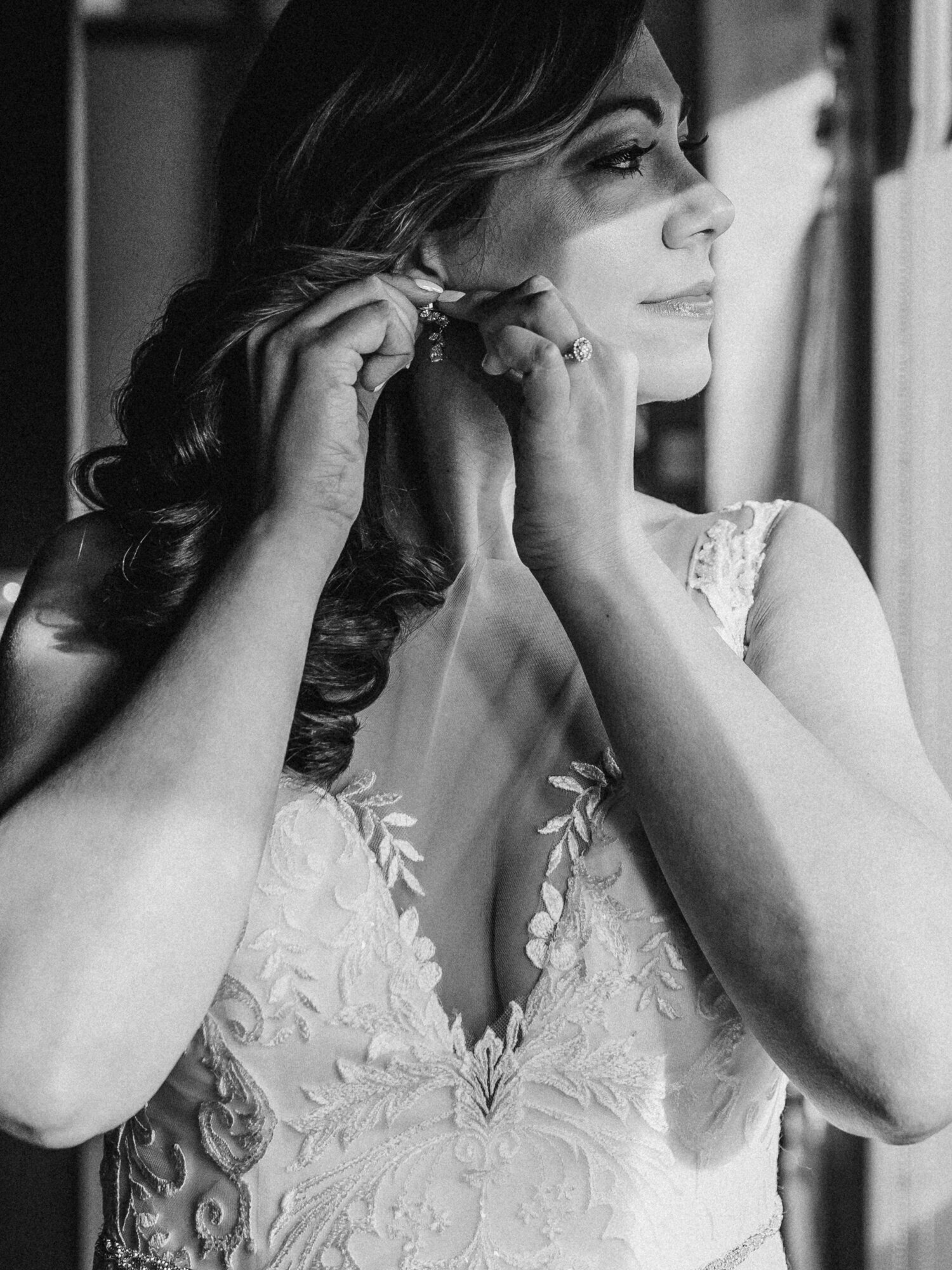 A black and white candid photo of a bride getting ready on her wedding day in Chicago