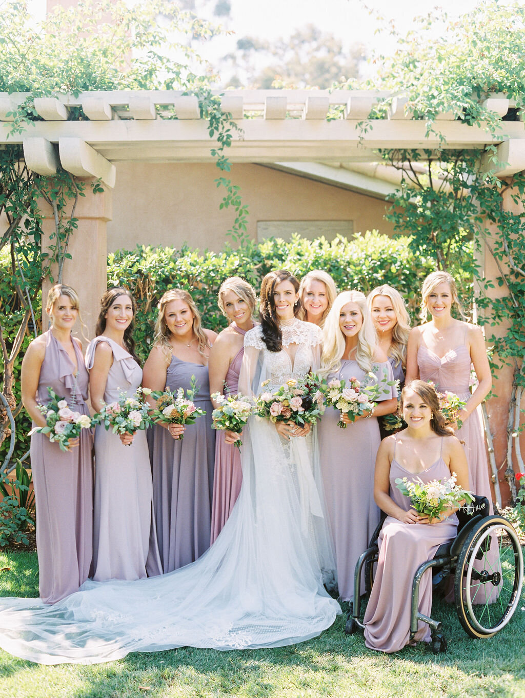 Bride with bridesmaids wearing lavender dresses at Rancho Valencia in San Diego