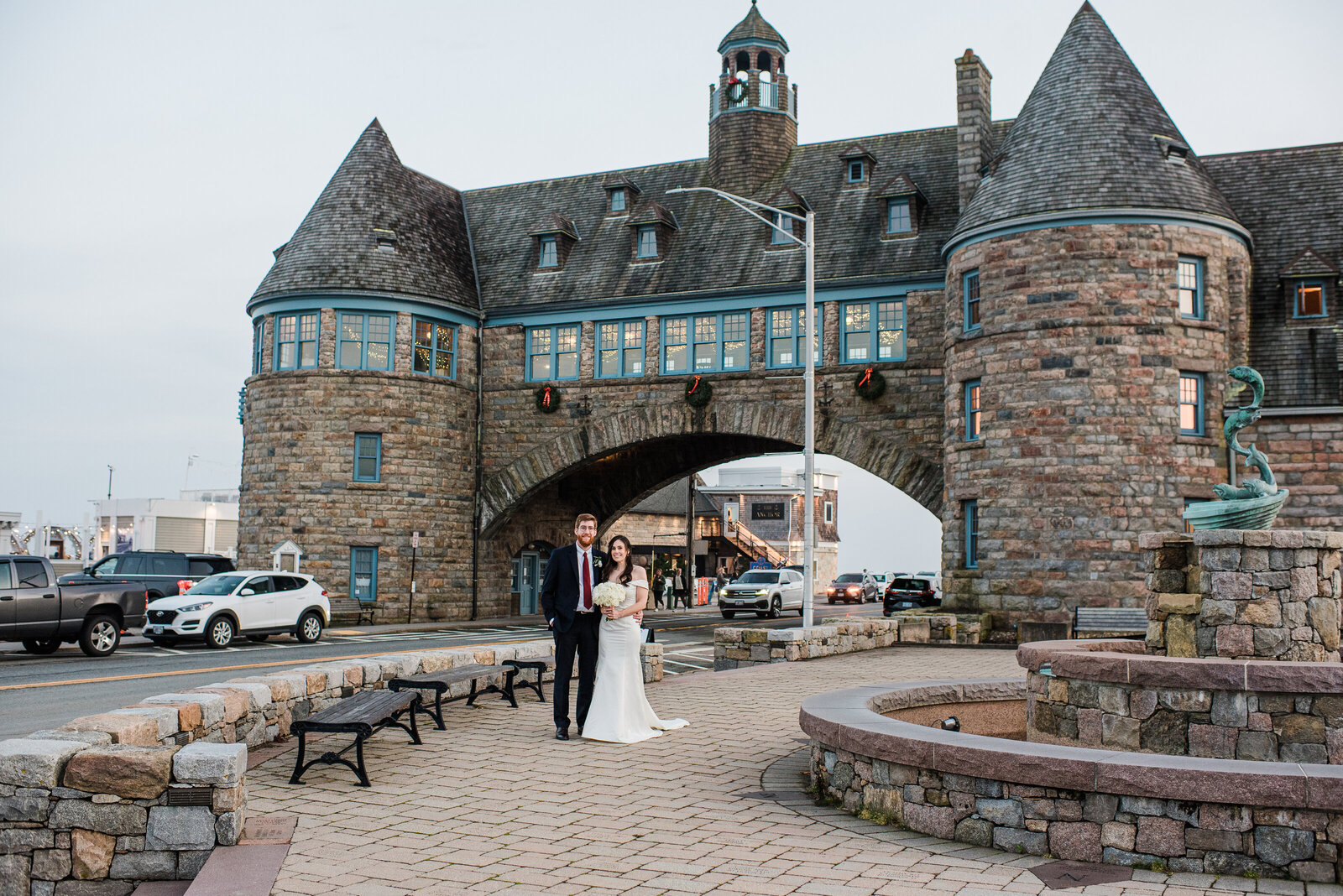 bride and groom in front of Narragansett Towers