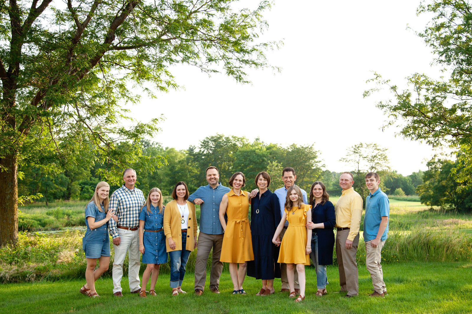 Extended family lined up and smiling. 
