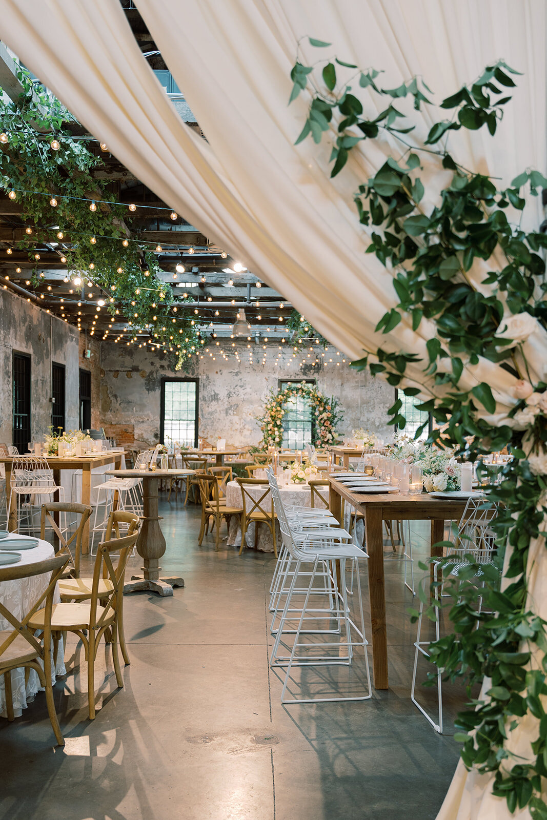 Reception set up at the Washington mill dye house with lush greenery and blush, peach and white florals.