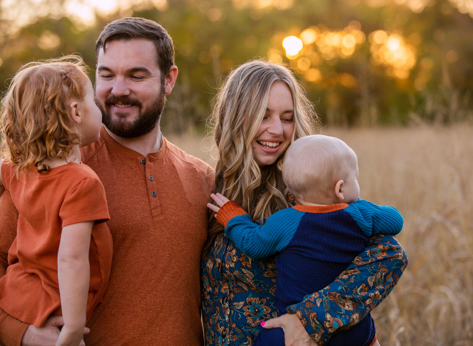 mom and dad holding kids