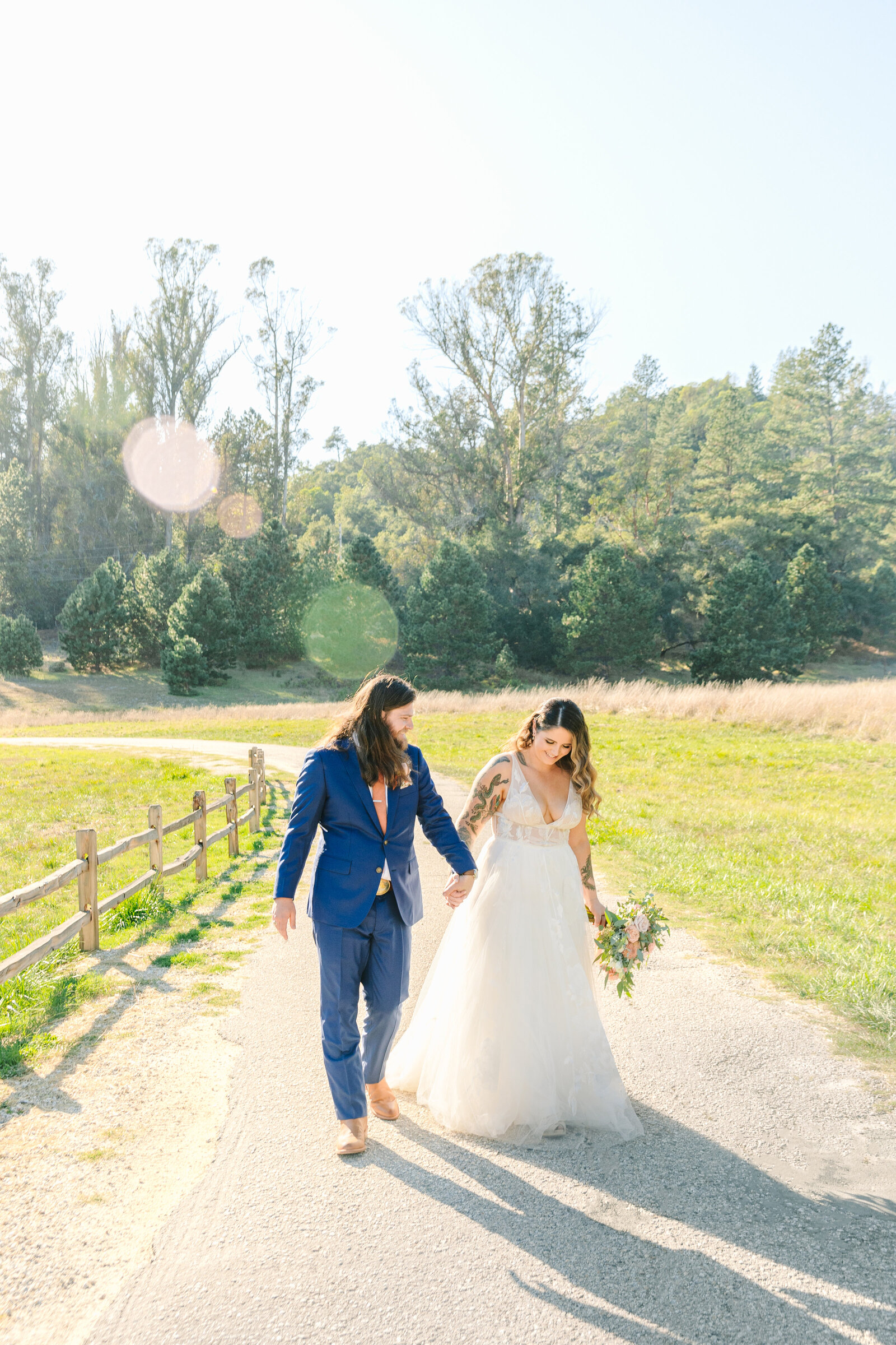 Tattoo bride and groom embrace on their colorful wedding day in Santa Cruz, California.