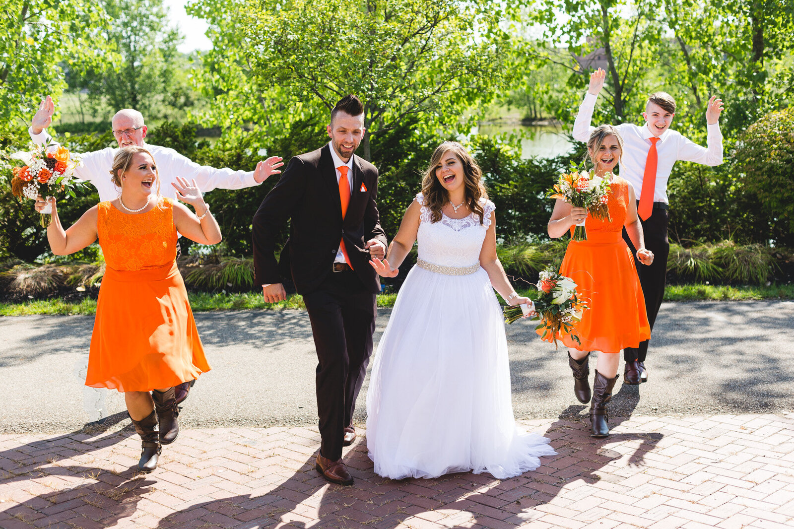 bridal party dancing in orange during portraits ohio wedding