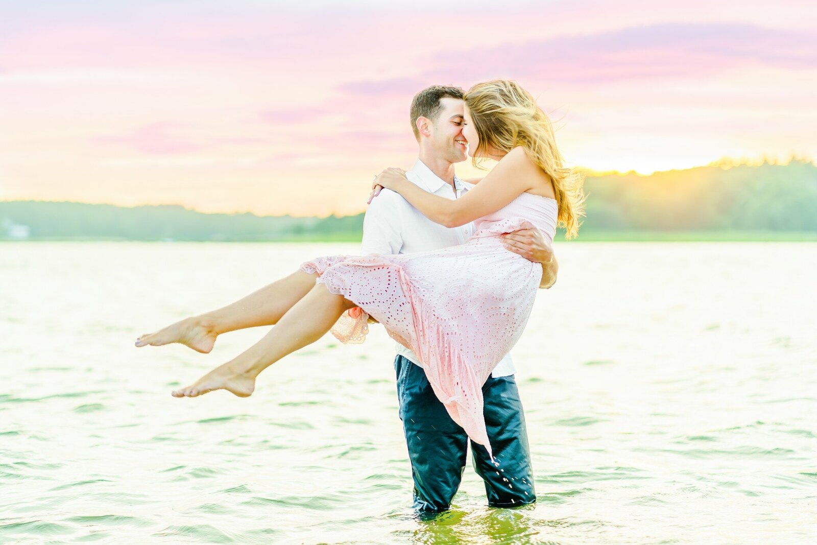 New England Area Couple standing in water smiling for engagement photos