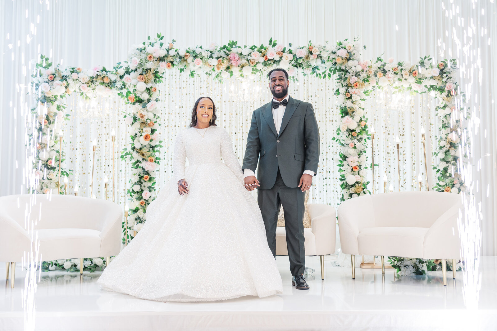 Bride and groom on stage inside wedding venue