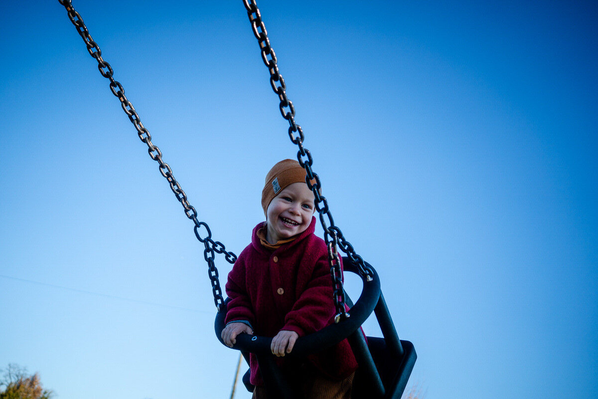 child on swing in victoria park bristol