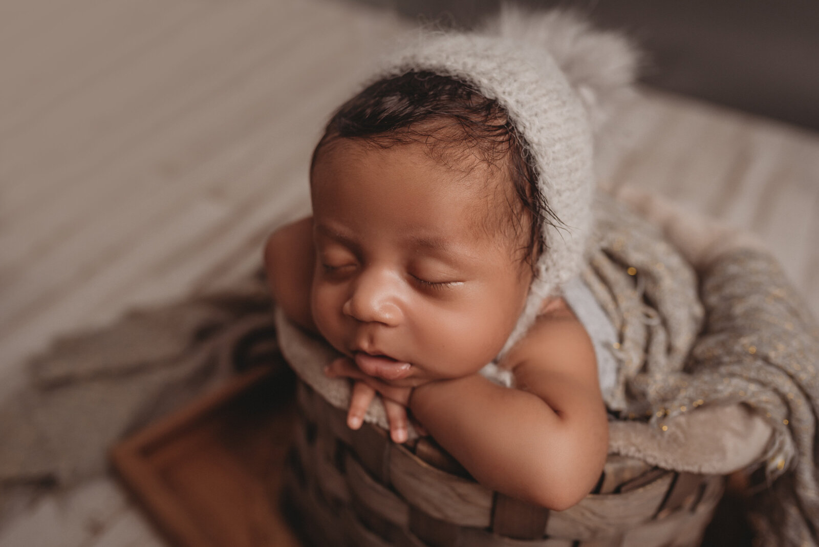 Newborn baby laying in basket