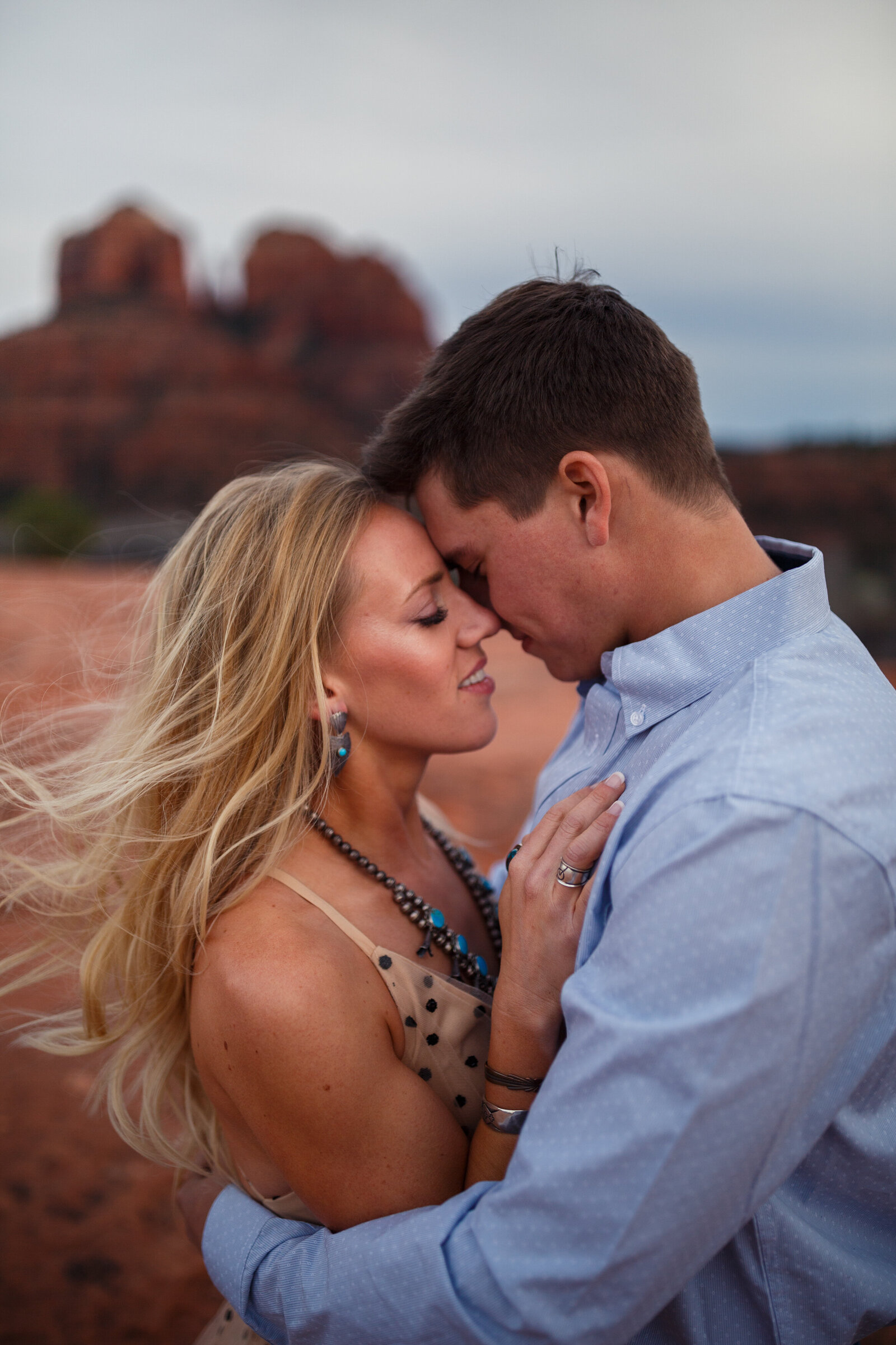 ranch couple kissing on a windy day