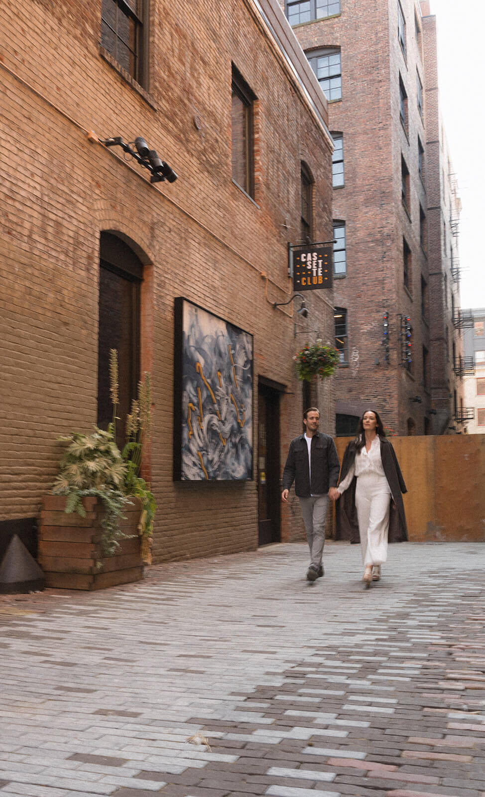 stylish couple walking hand in hand wearing fall clothing