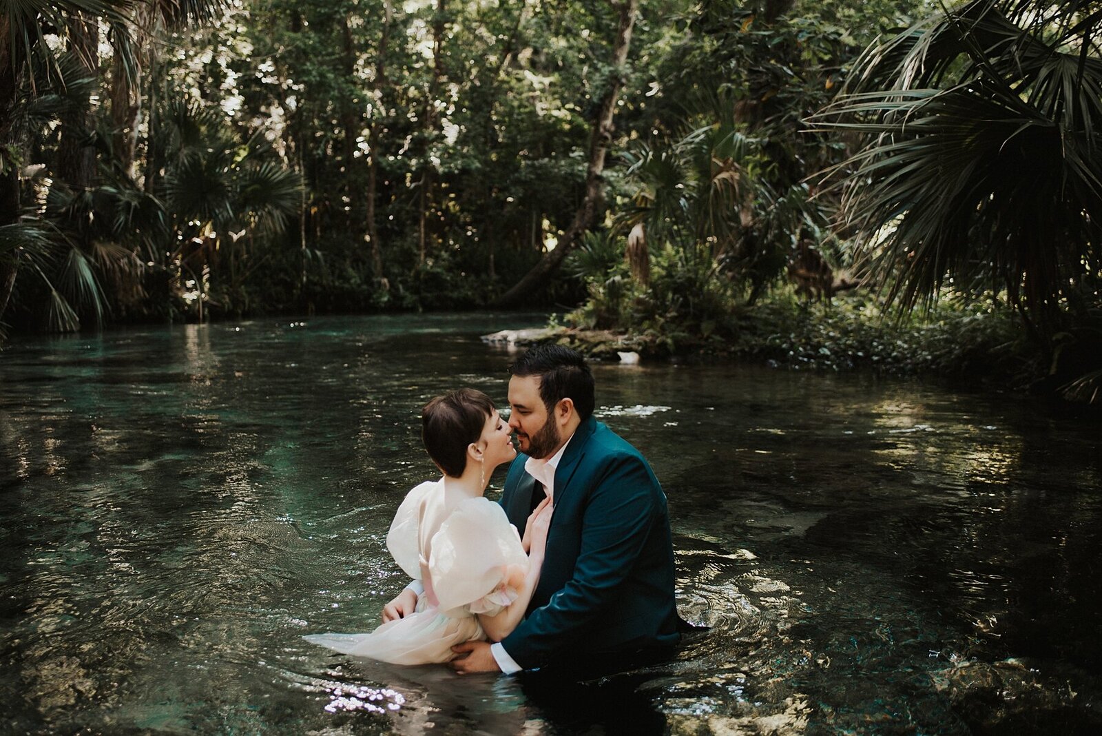 Couple kissing in the water of a spring captured by Florida Elopement Photographer, Anna Holden Photo
