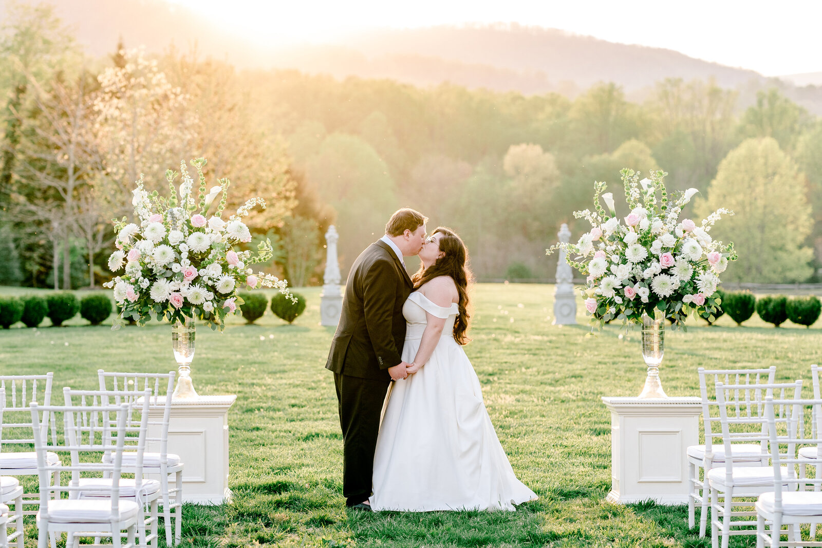 A bride and groom share a kiss in golden hour light during their wedding at The Inn at Little Washington in Virginia