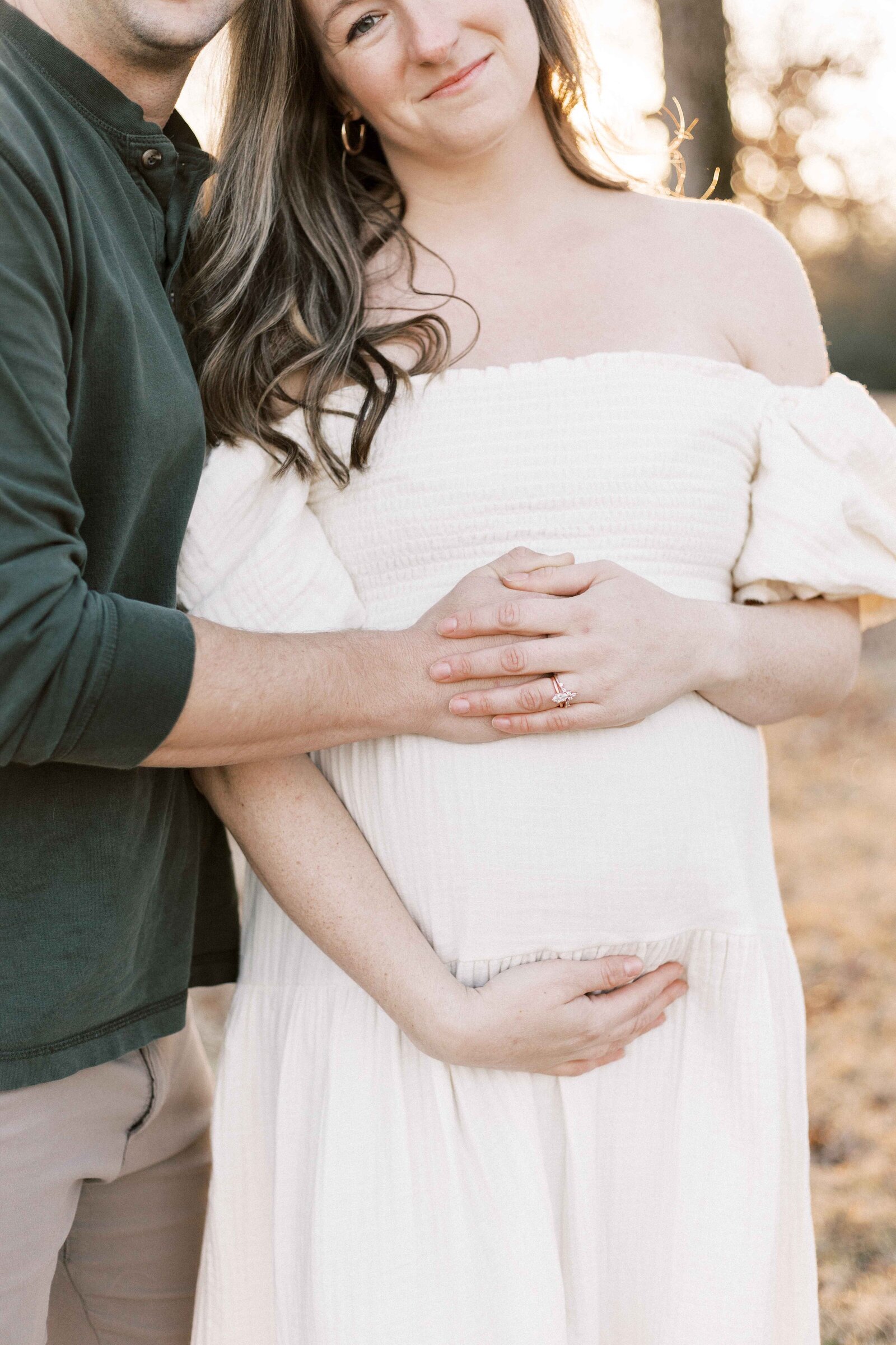 parents cradling baby bump during maternity photos in peoria illinois 