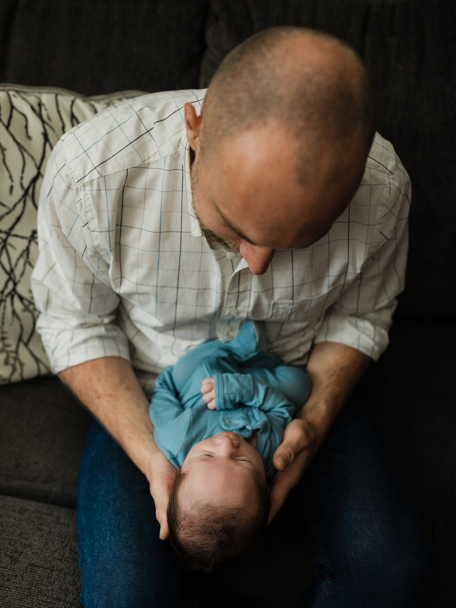 dad holding newborn baby boy for in home lifestyle session 