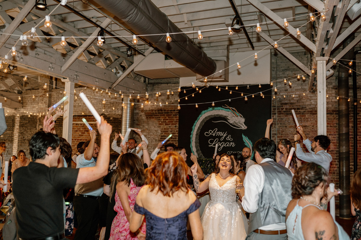 Wedding guests dancing with glow sticks