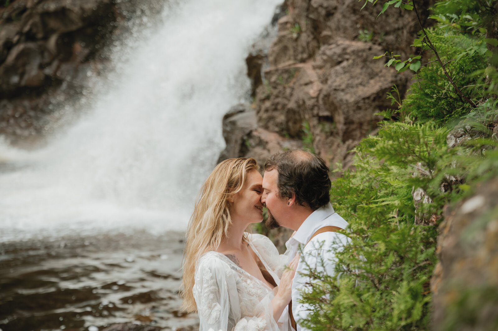 Couples kissing by the Caribou Falls in North Shore, Minnesota