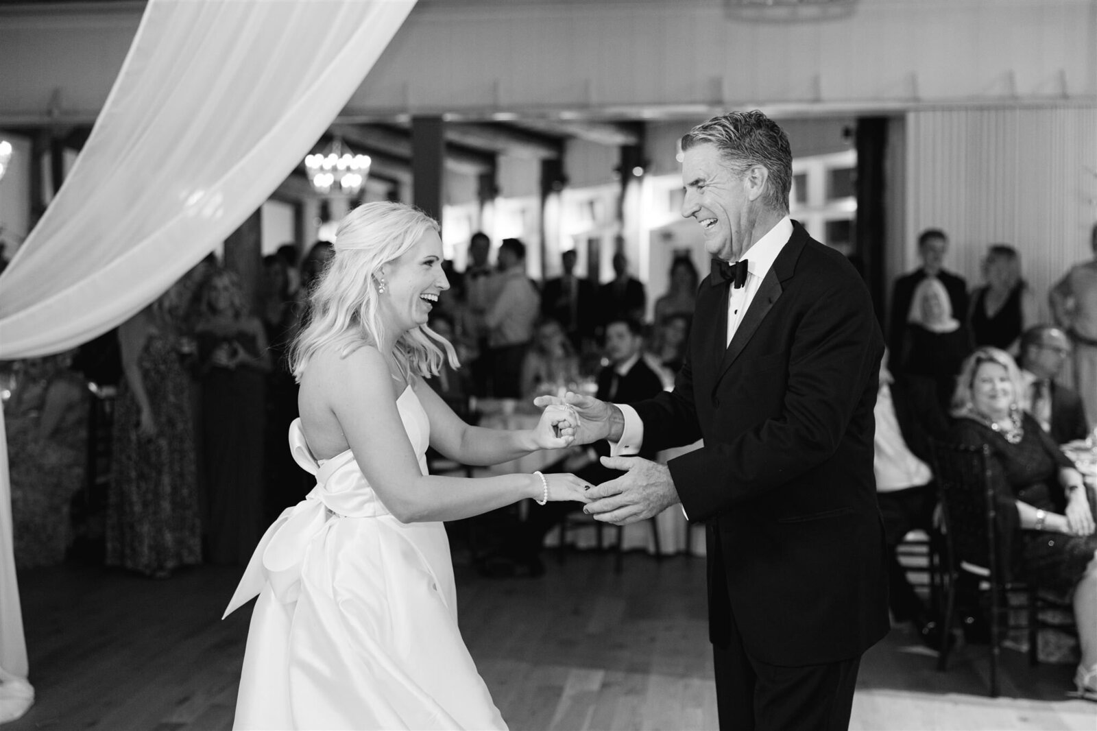 A bride dancing with her father at Mission Point Resort